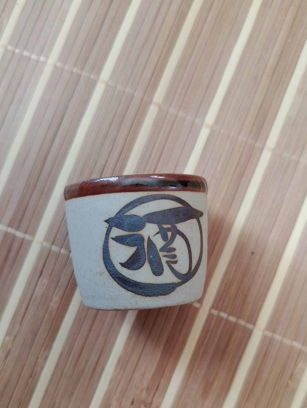 Handcrafted Ceramic Sake Cup in Cream and Brown with Stylized Motif